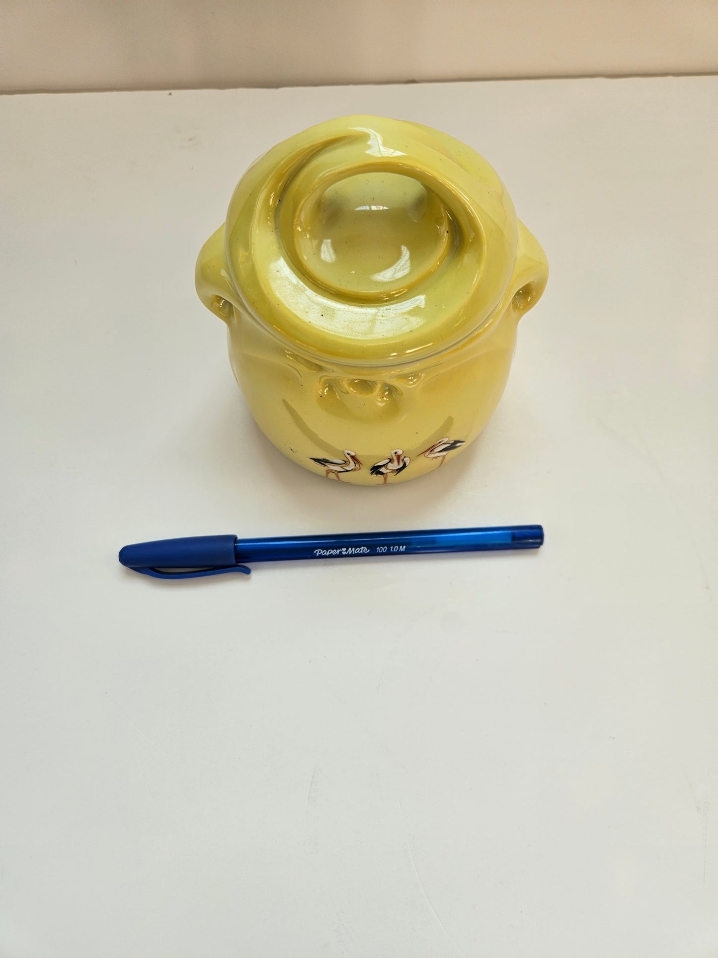 Yellow ceramic jar on a white background