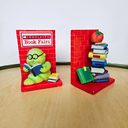 Colorful toy bookshelf with books and a toy character on a wooden surface.